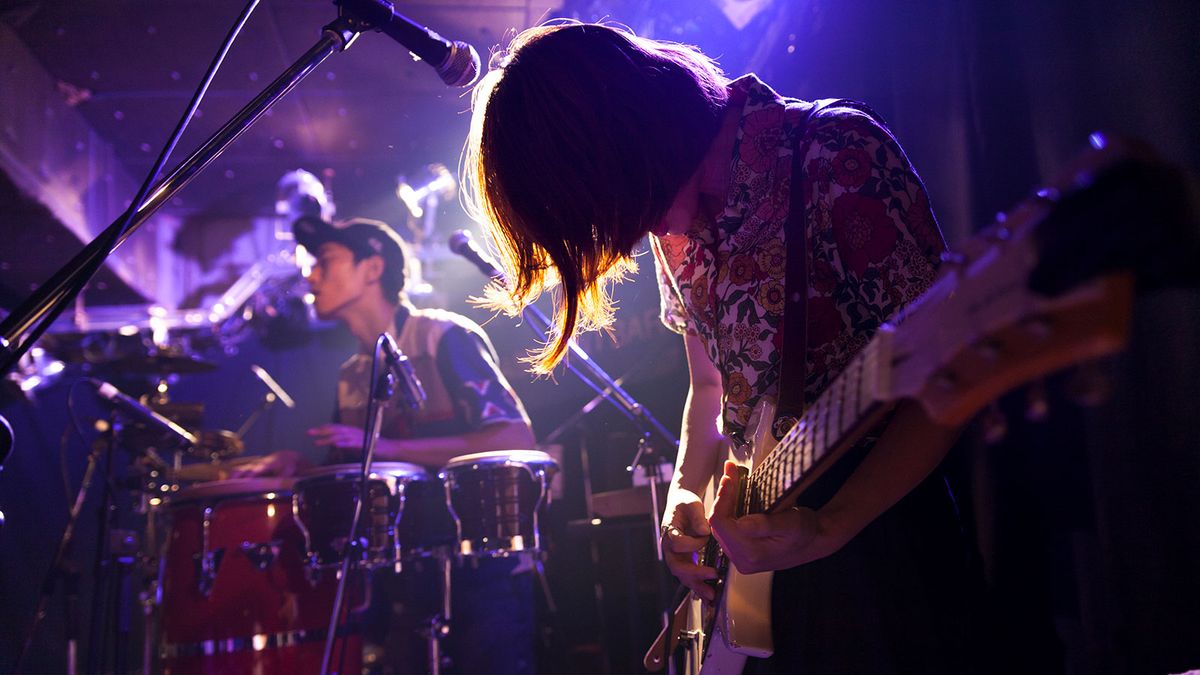 Female guitarist performing live