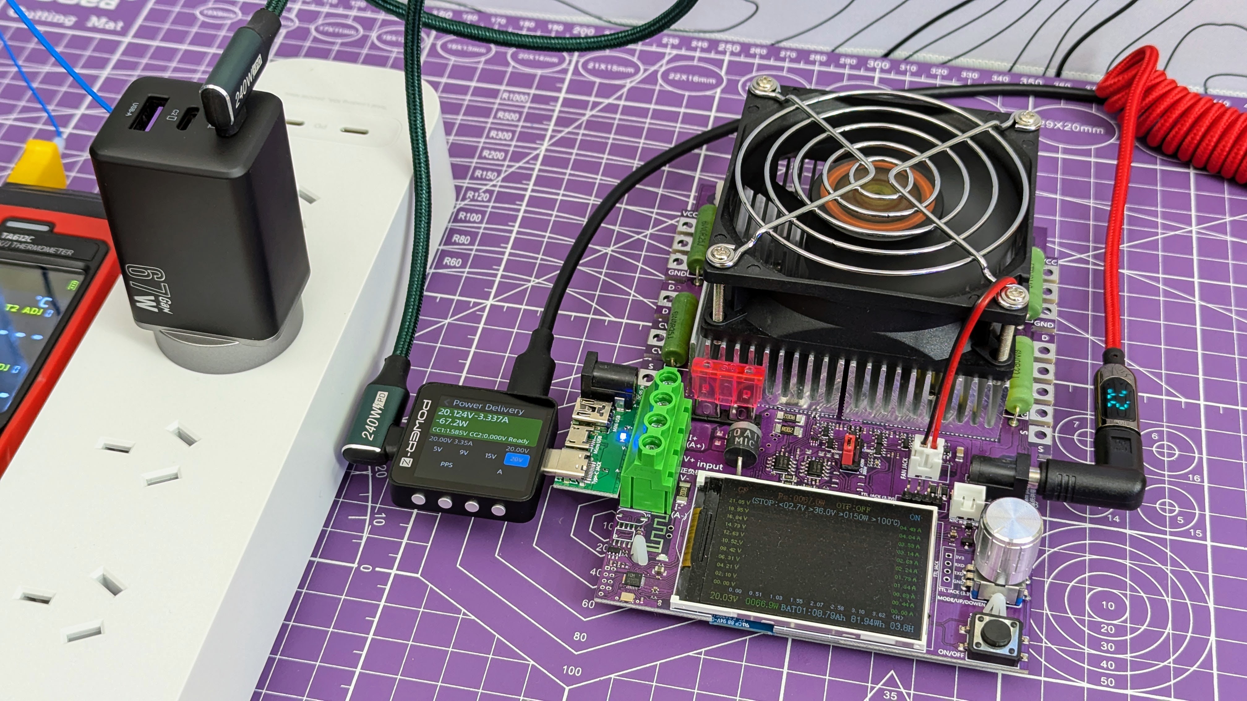 Novoo RG68 USB-C charger connected to load testing equipment, running at 67W