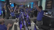 Members of NASA's OSIRIS-REx asteroid sample-return mission team celebrate after receiving word that the probe completed an attempt to collect samples of asteroid Bennu 207 million miles from Earth on Oct. 20, 2020. 