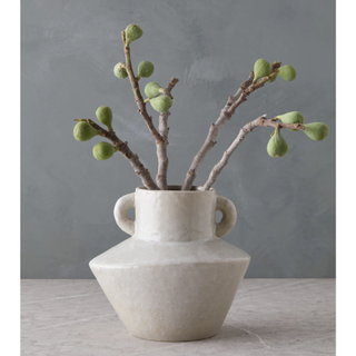 grey stoneware vase with twigs in it
