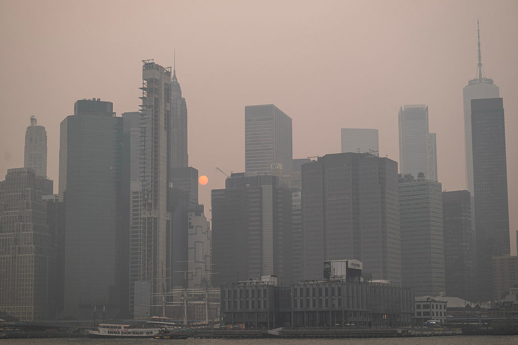 Smoke from wildfires in Canada shrouds the Manhattan skyline in the Brooklyn borough of New York, US, on Thursday, July 16, 2026. Across a broad section of North America, dangerous levels of smoke are engulfing major cities as hundreds of wildfires burn through Canada and send plumes across the continent. Photographer: Victor J. Blue/Bloomberg