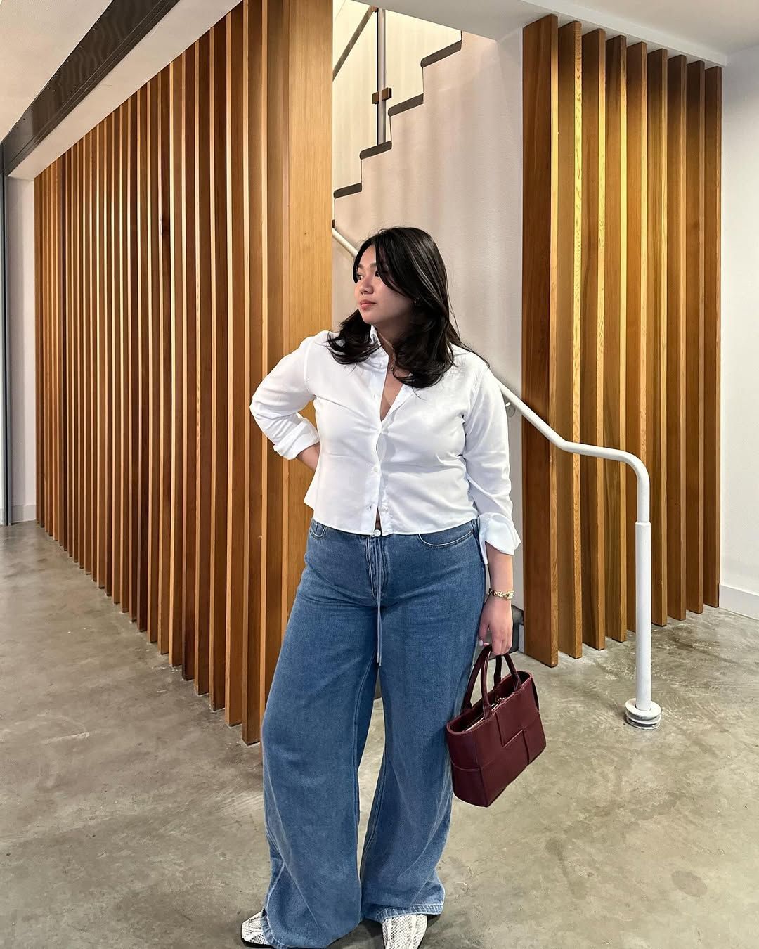 woman wearing Still Here NYC jeans and white top