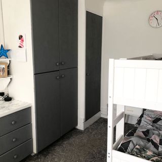 bathroom with grey wardrobe and bright white wall