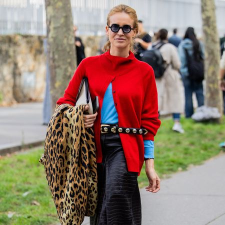 Woman in a red sweater and a leopard print coat
