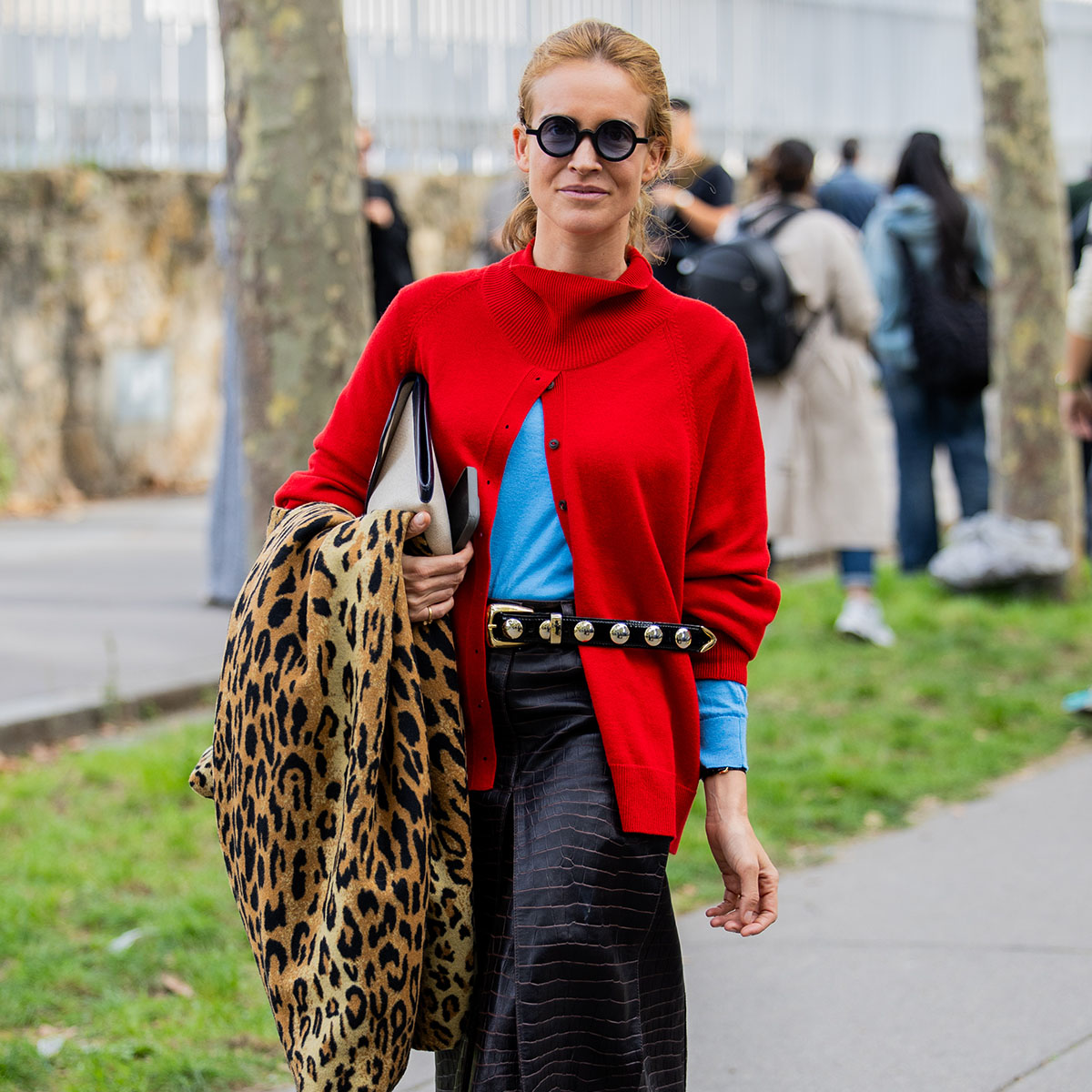 Woman in a red sweater and a leopard print coat