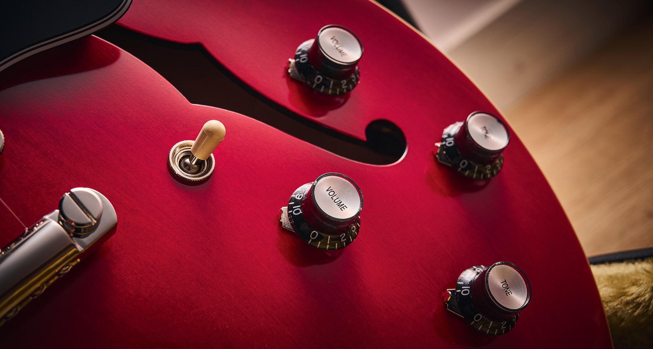 Epiphone Inspired By Gibson Custom 1962 ES-335 Reissue: the handsome semi-hollow electric is finished in Sixties Cherry and is photographed against various backgrounds.