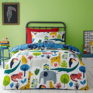 A green childrens bedroom with a bed with a bright coloured animal print duvet set