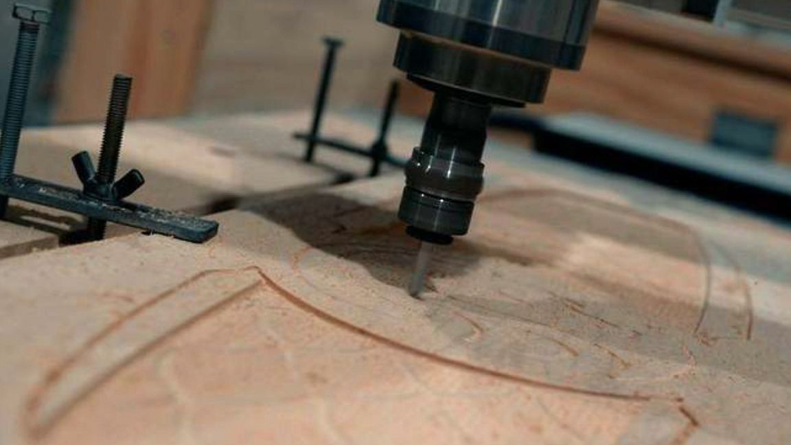 Bear Walker; cutting a wooden board