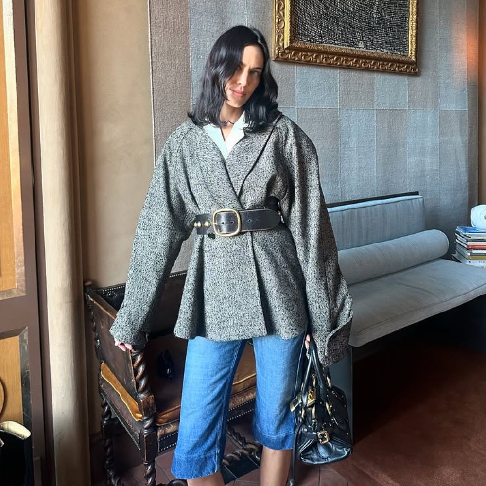 Alexa Chung wears Chloe denim capri pants with a grey wrap jacket and a chunky belt.