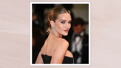 Rosie Huntington-Whiteley is pictured wearing a black dress whilst attending the &quot;The Substance&quot; Red Carpet at the 77th annual Cannes Film Festival at Palais des Festivals on May 19, 2024 in Cannes, France/ in a light, muted pink template