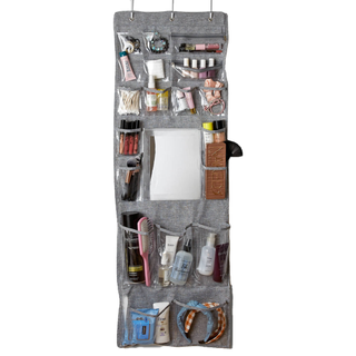 A grey over-the-door vanity organizer with makeup and beauty products