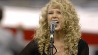 Taylor Swift sings the National Anthem as the Detroit Lions host the Miami Dolphins in a Thanksgiving Day game at Ford Field in Detroit, Michigan on November 23, 2006. (Photo by Al Messerschmidt/Getty Images)