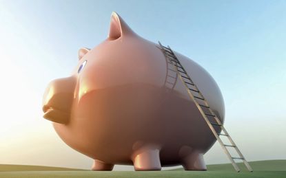 Ladder leading to top of large piggy bank