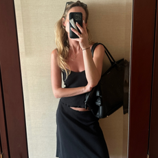 An image of a woman wearing summer knee length skirt outfit 2026