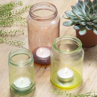 Multicolour Scented candle with glass jar and wooden table
