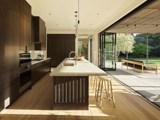 modern kitchen with grooved island and doors that open onto a terrace