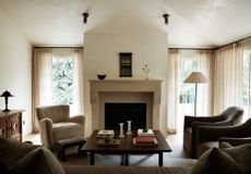 A living room with sheer, neutral curtains