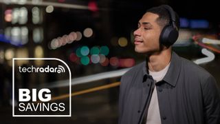 A man wearing the Sony WH-1000XM5 headphones outside at night.