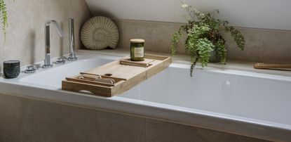 wood bath caddy over a modern bath tub