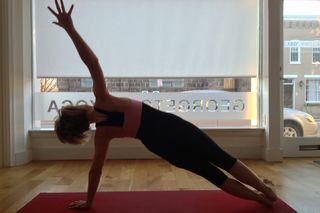 Yoga can be a powerful tool to help you improve overall health. Here, Katherine Tallmadge presents a side plank pose at Georgetown Yoga.