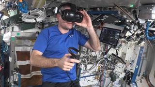 an astronaut wearing a vr headset in a crowded space station module