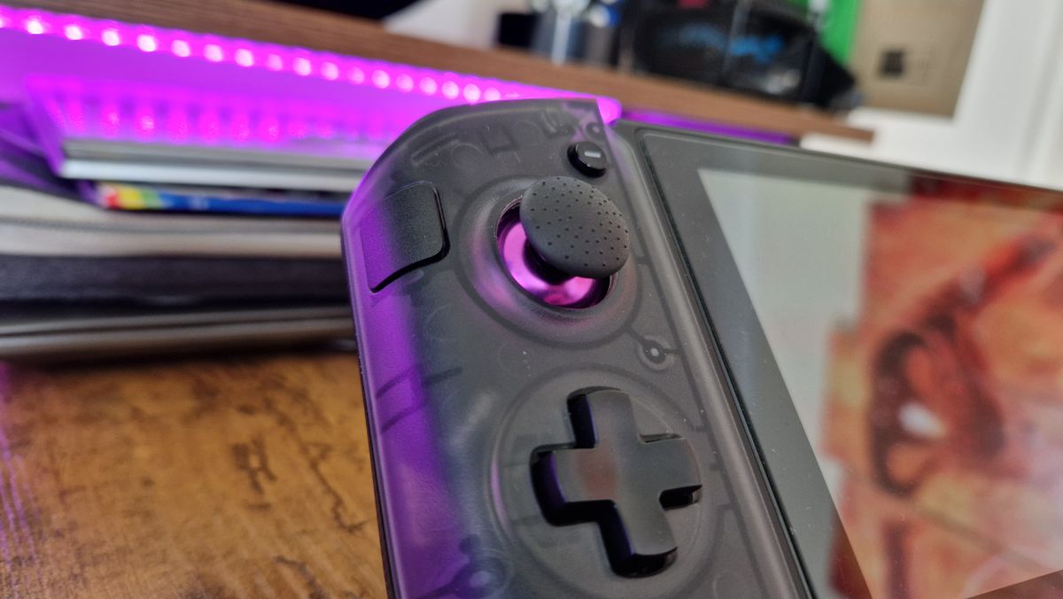 CRKD Nitro Deck+'s left side, showing its textured joystick and sidekick button