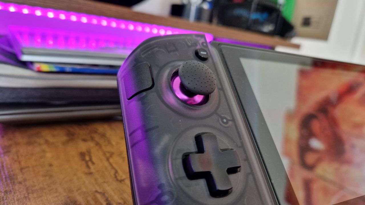 CRKD Nitro Deck+'s left side, showing its textured joystick and sidekick button