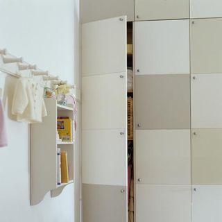 kids room with neutral painted wall and built in cupboards