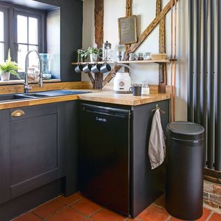 black painted kitchen with wooden worktops