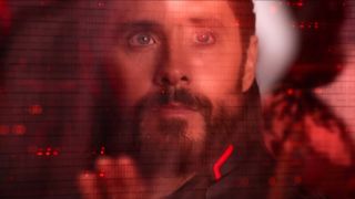 Jared Leto looks up at a field of videos and code with longing in Tron: Ares.