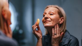 woman applying makeup