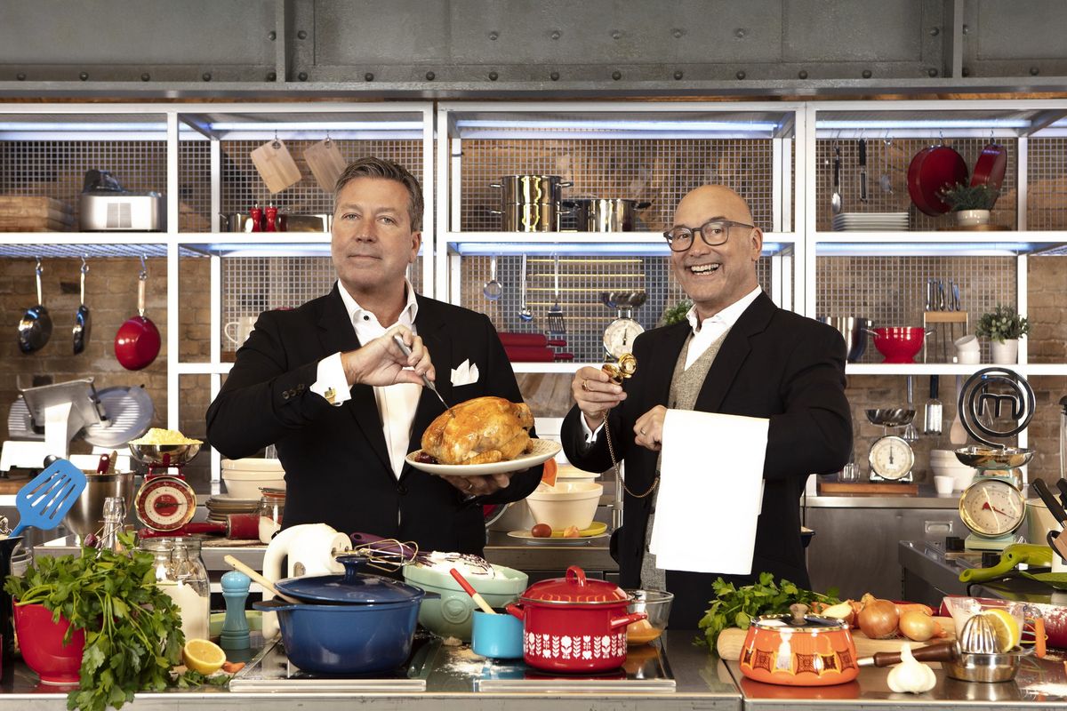 Posed shot of John Torode and Gregg Wallace surrounded by delicious food