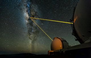 The two W. M. Keck Telescopes on Mauna Kea, Hawaii, observing the galactic center. The lasers are used to create an artificial star in Earth's upper atmosphere, which is then employed to measure the blurring effects of the lower atmosphere (the effect that makes the stars twinkle in the night sky). The blurring gets corrected in real time with the help of a deformable mirror. This is the so-called adaptive optics technique. Image released October 4, 2012.