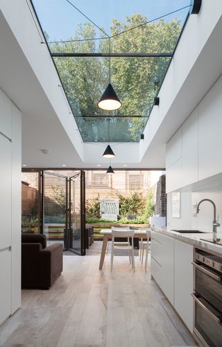 Modern extension by Bolton Chalklin Architects with glazed roof and bi-fold doors