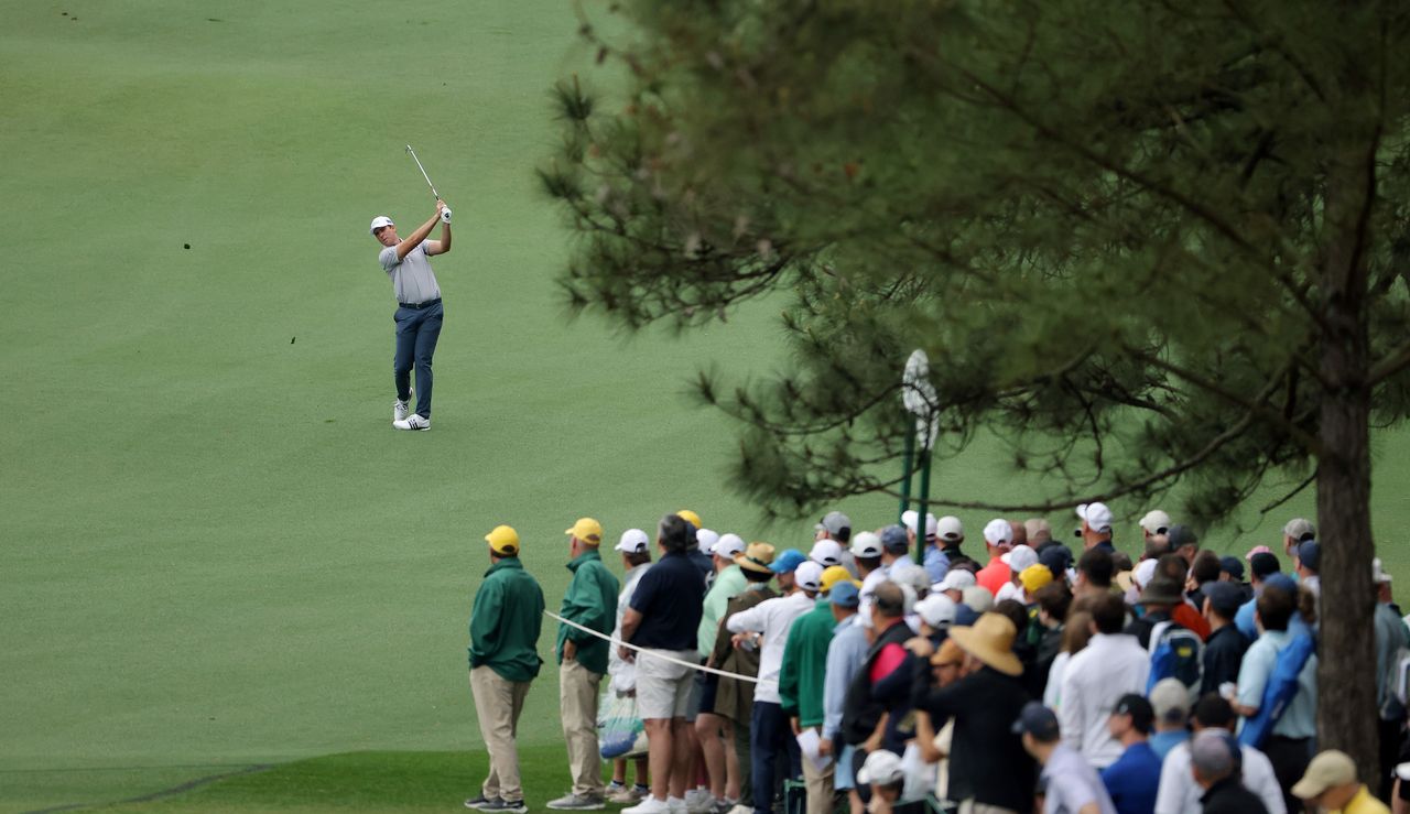 Luke List hits a shot from the middle of the fairway surrounded by patrons