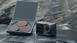 DJI Osmo Action 4 camera on a rock alongisde the case containing ND filters