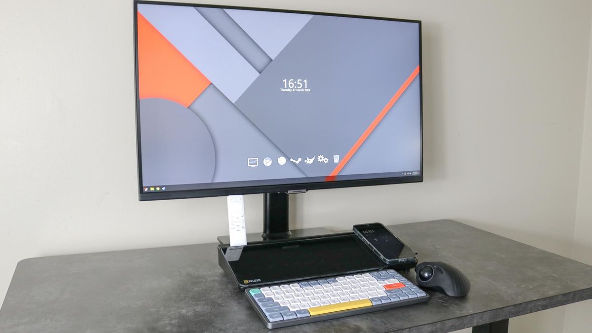 A desktop whiteboard on a desk with a keyboard and monitor