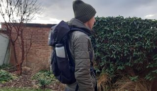 Side view of fitness writer Lily Canter wearing the Vaude Brenta 30 backpack outdoors