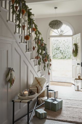 Hallway with Christmas decorations by Layered Lounge