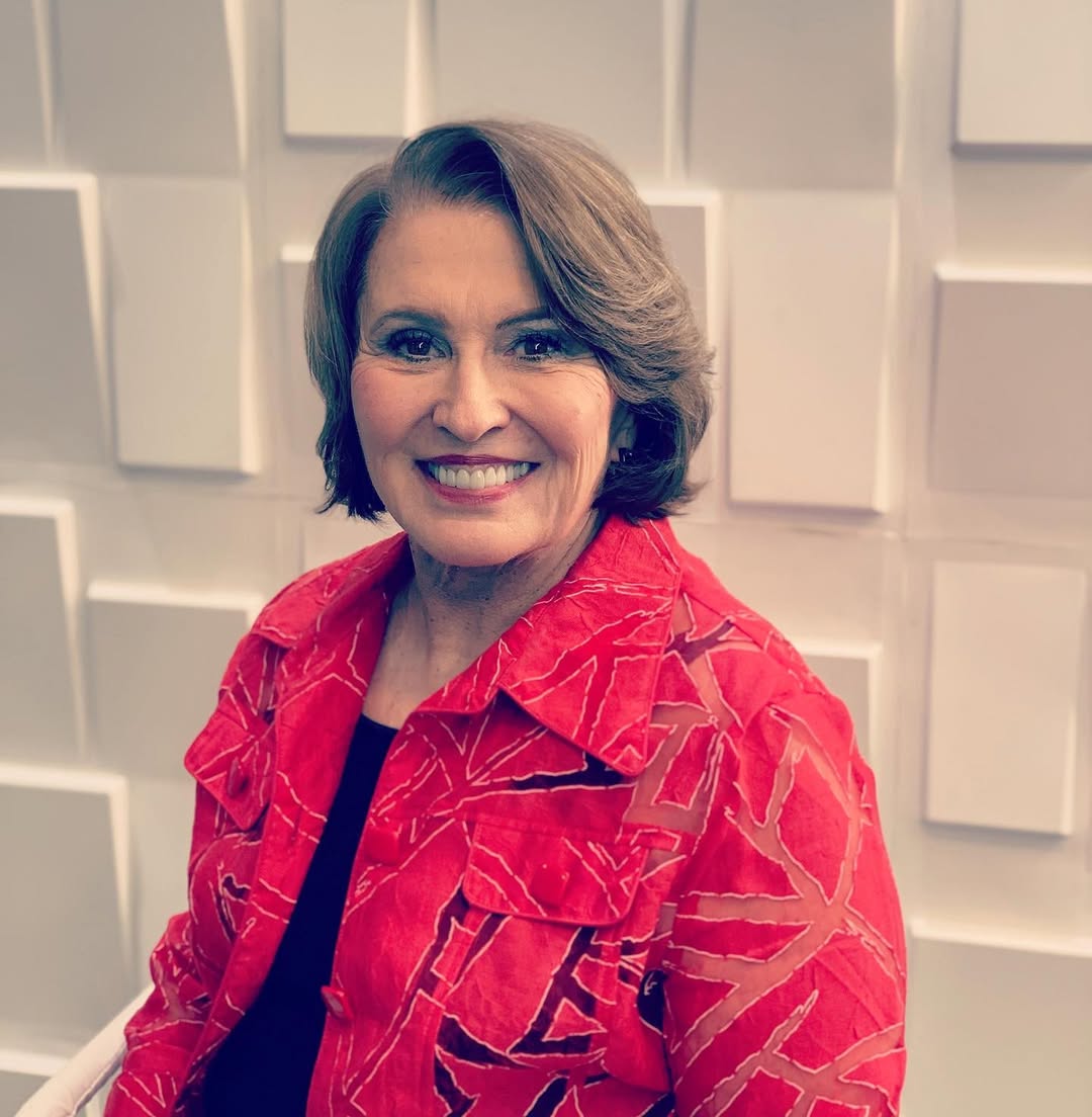a close up photo of a woman wearing a red jacket with a black shirt