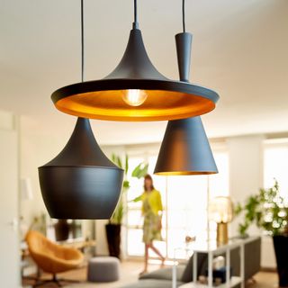 a trip of Tom Dixon pendant lights fitted with smart lightbulbs