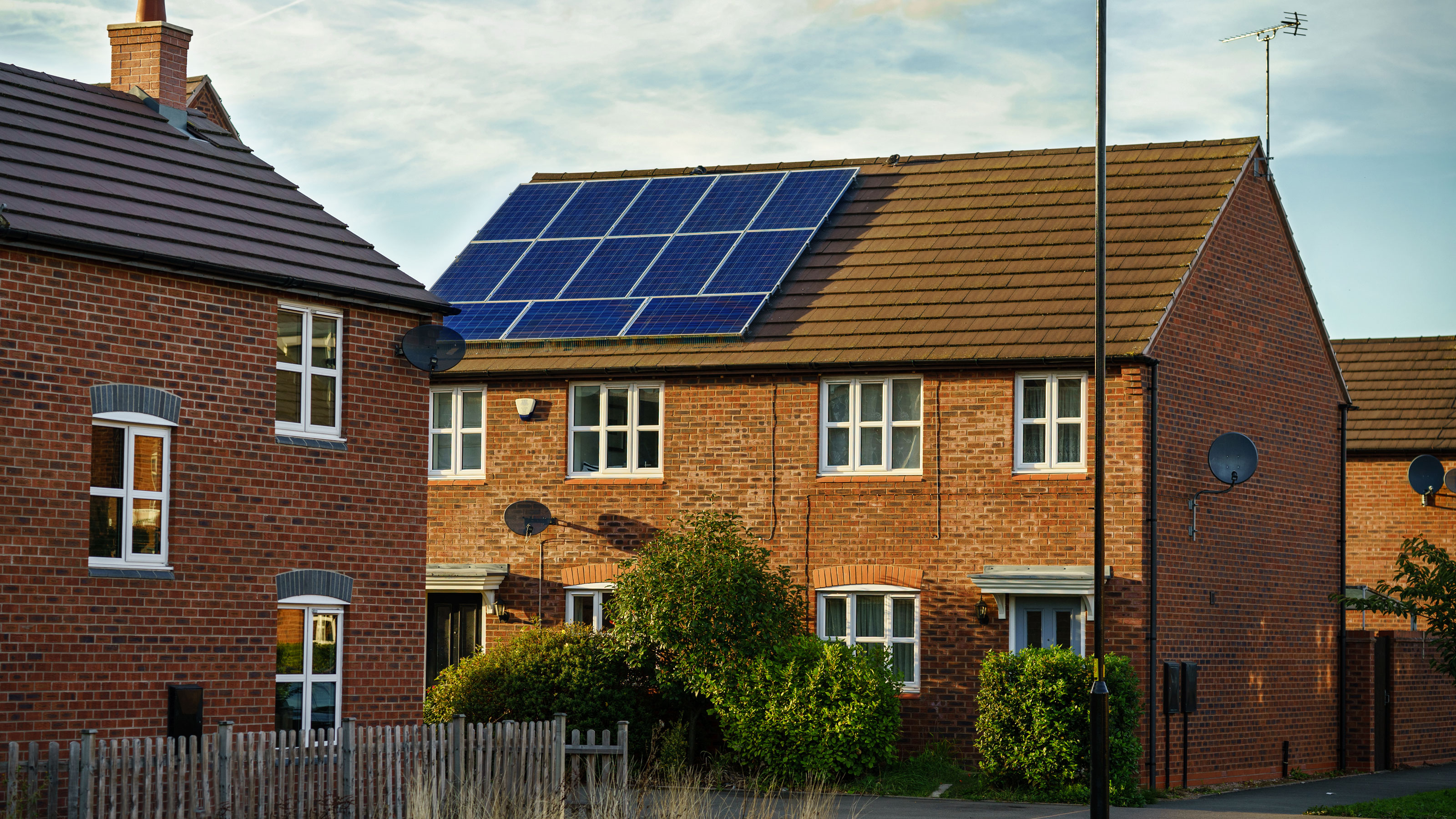 Solar panel on the roof of a red brick house