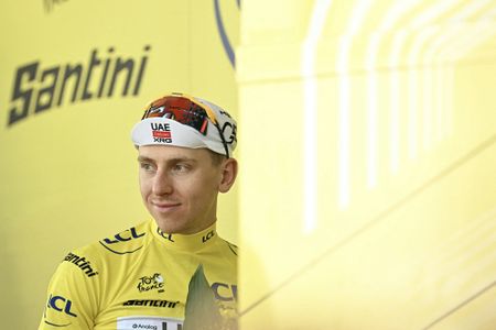 UAE Team Emirates - XRG's Slovenian rider Tadej Pogacar celebrates on the podium with the overall leader's yellow jersey after the 9th stage of the 113th edition of the Tour de France cycling race, 154,6 km between Malemort and Ussel in central France, on July 12, 2026. (Photo by Loic VENANCE / AFP)