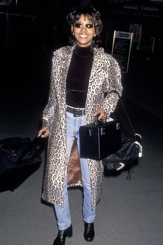 Actress Halle Berry wears jeans and a leopard print coat on December 9, 1994 as she departs for Washington, DC from Los Angeles International Airport in Los Angeles, California.