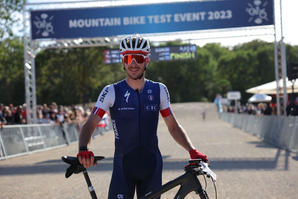 Frances Victor Koretzky poses with his bicycle after winning the Mens Elite Cross Country mountain biking test event at Elancourt Hill in Elancourt west of Paris on September 24 2023 Photo by Thomas SAMSON AFP Photo by THOMAS SAMSONAFP via Getty Images