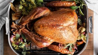 One of the best turkey roasting pans, an All-Clad turkey roasting pan with a roast turkey