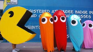   folks dressed as pac man and four of the video game's ghost characters