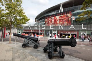 Two fans were evicted from the Emirates Stadium after aiming homophobic abuse at travelling Brighton supporters.
