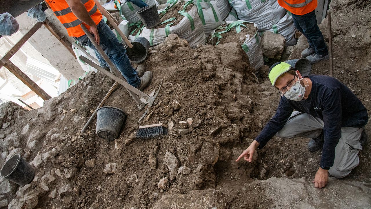 Excavation director David Gellman with the Israel Antiquities Authority points to the spot where the gold-filled jug was found opposite the Western Wall Plaza.