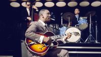 American jazz guitarist Wes Montgomery (1923-1968) performs with a Gibson L-5 semi acoustic guitar in a television studio during a recording for the television series 'Tempo' in 1965